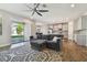 Open-concept living room with a large sectional sofa and access to the backyard patio at 13083 Burns Dr, Odessa, FL 33556