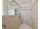 Modern tile shower features built-in bench, niche and seamless glass door for a spa-like experience at 13083 Burns Dr, Odessa, FL 33556