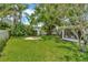 Expansive backyard featuring lush green grass and mature landscaping, perfect for outdoor enjoyment at 709 S Himes Ave, Tampa, FL 33609