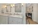 Bright bathroom features double vanity with marble countertops, mirrors, and updated fixtures at 709 S Himes Ave, Tampa, FL 33609