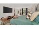 This bedroom offers a TV, a plush bed with pillows, and access to the outdoor areas at 709 S Himes Ave, Tampa, FL 33609