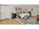 Inviting bedroom featuring a bed, a black nightstand, art decorations, and hardwood floors at 709 S Himes Ave, Tampa, FL 33609