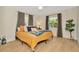 Bedroom with a ceiling fan, wood floors, modern decor, and natural light at 709 S Himes Ave, Tampa, FL 33609