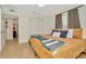 Bedroom with ceiling fan, ensuite access, closet, and light-colored wood floors at 709 S Himes Ave, Tampa, FL 33609
