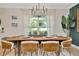 Dining room featuring elegant table setting, chandelier, and natural light at 709 S Himes Ave, Tampa, FL 33609