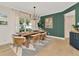 Elegant dining room with modern chandelier, table set for four and a lovely accent wall at 709 S Himes Ave, Tampa, FL 33609