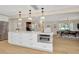 Spacious kitchen with center island, stainless steel appliances, and white cabinetry open to dining room at 709 S Himes Ave, Tampa, FL 33609