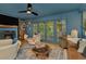 Blue living room with fireplace, wood floors, modern furniture and access to patio at 709 S Himes Ave, Tampa, FL 33609