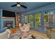 Inviting living room with fireplace, wood floors, comfortable furniture and access to screened in patio at 709 S Himes Ave, Tampa, FL 33609