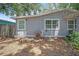 Back of the house shows the wall and window and the foliage on the ground at 9307 N Oakleaf Ave, Tampa, FL 33612