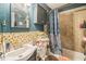 Bathroom featuring a toilet, tub, mosaic tiling and vanity sink at 9307 N Oakleaf Ave, Tampa, FL 33612