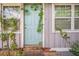 Exterior home facade showing light blue front door, windows and vegetation at 9307 N Oakleaf Ave, Tampa, FL 33612