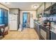 Kitchen with dark cabinets, tile flooring, and stainless steel appliances at 9307 N Oakleaf Ave, Tampa, FL 33612