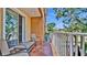 Relaxing balcony view featuring a seating area with chairs, a table, and white railings overlooking the neighborhood at 5016 W Lancaster St # 00, Tampa, FL 33616