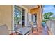 Balcony featuring orange tiled floor, a metal table with two chairs, and white door at 5016 W Lancaster St # 00, Tampa, FL 33616