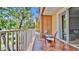 Balcony featuring an orange tiled floor, a metal table with two chairs, and white rails at 5016 W Lancaster St # 00, Tampa, FL 33616