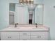 Bright bathroom featuring a double vanity, large mirror, and a glass-enclosed shower at 5016 W Lancaster St # 00, Tampa, FL 33616