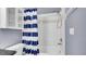 Bright bathroom with a shower and blue and white striped curtain at 5016 W Lancaster St # 00, Tampa, FL 33616