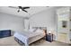 This is a bedroom with a bed, ceiling fan, and attached bathroom at 5016 W Lancaster St # 00, Tampa, FL 33616