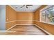 Bedroom featuring an orange wall, a ceiling fan, and laminate flooring at 5016 W Lancaster St # 00, Tampa, FL 33616