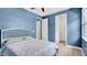 Stylish bedroom featuring a blue accent wall and walk-in closet at 5016 W Lancaster St # 00, Tampa, FL 33616