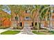 Inviting townhouse exterior with a white fenced balcony, a one car garage and neat landscaping at 5016 W Lancaster St # 00, Tampa, FL 33616