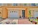 Charming townhome exterior with a one-car garage, dark front door, and manicured landscaping at 5016 W Lancaster St # 00, Tampa, FL 33616