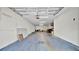 Spacious garage featuring a blue floor and fluorescent ceiling lights at 5016 W Lancaster St # 00, Tampa, FL 33616