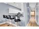 Kitchen bar with seating, stainless sink and microwave over cooktop at 5016 W Lancaster St # 00, Tampa, FL 33616