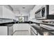 Bright kitchen featuring stainless steel appliances, granite countertops and white cabinets at 5016 W Lancaster St # 00, Tampa, FL 33616