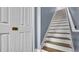 Close up view of the staircase featuring wood treads and white risers, next to a closet at 5016 W Lancaster St # 00, Tampa, FL 33616