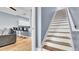 Staircase with wood treads and white risers, connecting the living space to the upper level at 5016 W Lancaster St # 00, Tampa, FL 33616