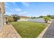 Spacious backyard with well-maintained lawn, bordered by a white fence for privacy at 10227 Parsons St, Tampa, FL 33615