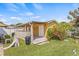Large backyard featuring a tan shed with a covered porch and various outdoor elements at 10227 Parsons St, Tampa, FL 33615