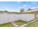 Fenced backyard has well-kept lawn and pathway, providing a serene outdoor setting at 10227 Parsons St, Tampa, FL 33615