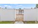 Backyard featuring a white fence, brick patio, and a private gateway at 10227 Parsons St, Tampa, FL 33615