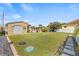 Large backyard featuring a detached garage, small building, and spacious green lawn at 10227 Parsons St, Tampa, FL 33615