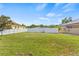Expansive green backyard with a white fence, offering ample space for recreation at 10227 Parsons St, Tampa, FL 33615