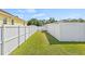 Narrow green backyard is enclosed by white fence, offering a private outdoor space at 10227 Parsons St, Tampa, FL 33615