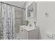 Bathroom featuring a shower with decorative curtain and a white sink and vanity at 10227 Parsons St, Tampa, FL 33615