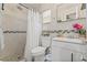 Modern bathroom featuring a shower, white vanity, and mosaic tile accents at 10227 Parsons St, Tampa, FL 33615