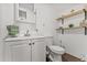 A clean bathroom with open shelves, a modern vanity, and tiled floors at 10227 Parsons St, Tampa, FL 33615