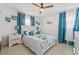 Inviting bedroom with blue accents, ceiling fan, and tile flooring at 10227 Parsons St, Tampa, FL 33615