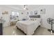 Well-lit bedroom with ceiling fan, tiled floors and makeup vanity at 10227 Parsons St, Tampa, FL 33615