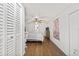 A vaulted bedroom with wood flooring, a ceiling fan, and a large closet at 10227 Parsons St, Tampa, FL 33615