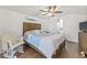 A large bedroom with wood flooring, a ceiling fan, and an ensuite bathroom at 10227 Parsons St, Tampa, FL 33615