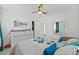 Bright bedroom with white furniture, fan, and closet access at 10227 Parsons St, Tampa, FL 33615