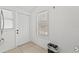 Bright entryway featuring tiled flooring, a window with blinds, and a white front door at 10227 Parsons St, Tampa, FL 33615