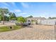 View of the exterior of this home featuring a brick paved driveway and gated fence at 10227 Parsons St, Tampa, FL 33615