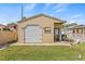 A detached garage features a roll up door and side entrance at 10227 Parsons St, Tampa, FL 33615